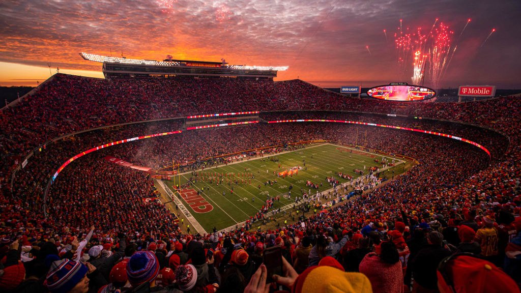Arrowhead Stadium at sunset, fireworks over the stands.